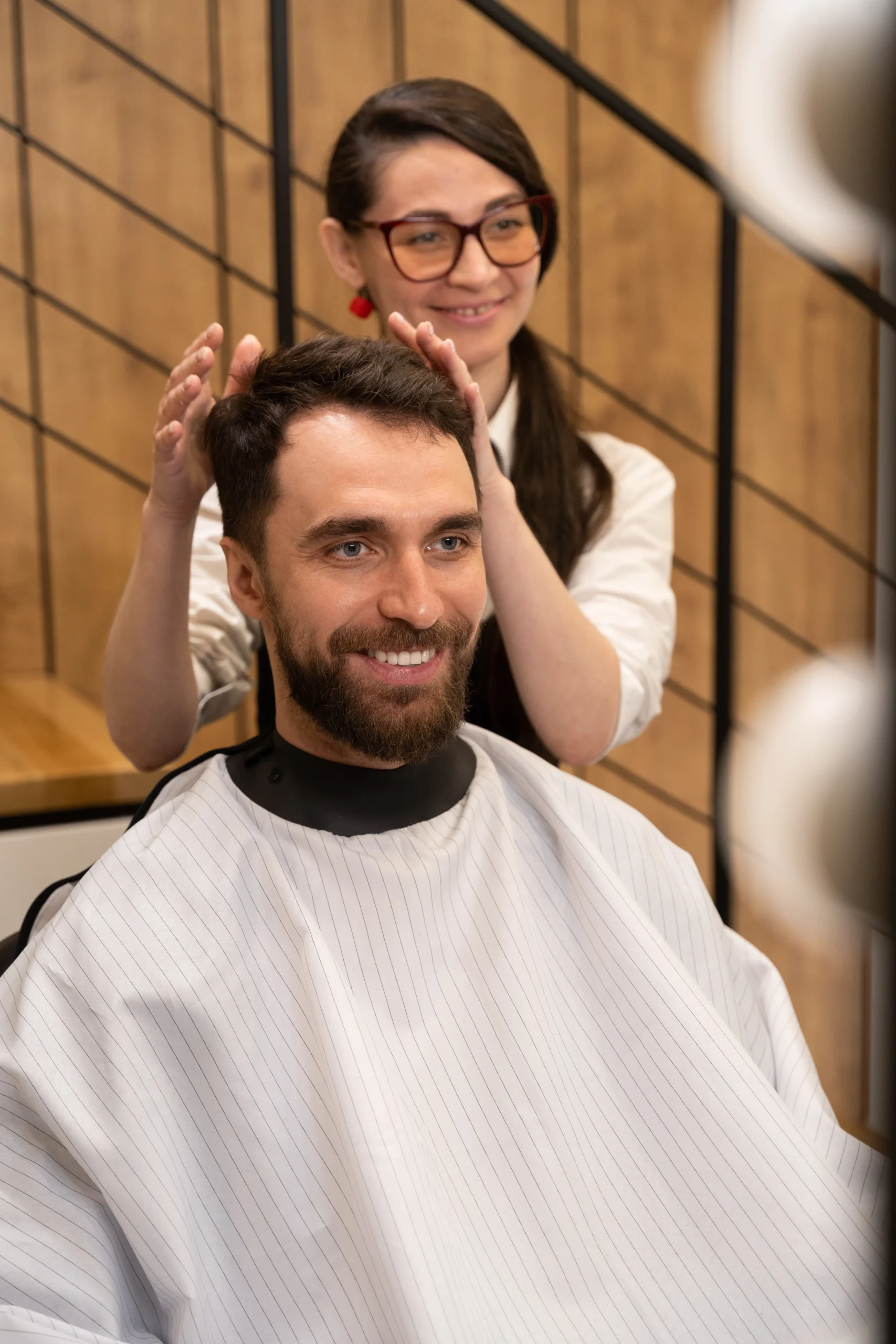 Hairdresser styling a client's hair.